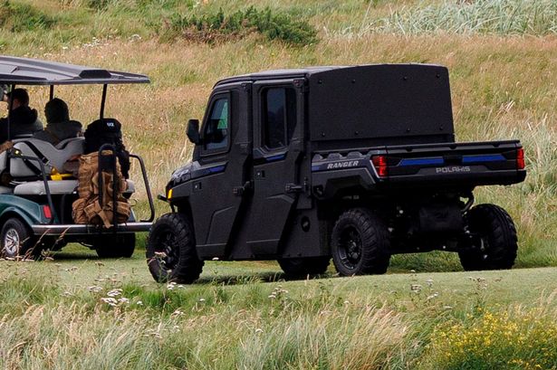 armored golf cart following Donald Trump in Scotland