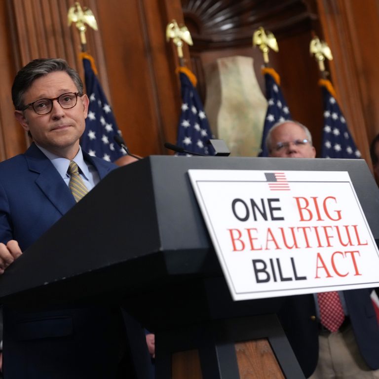 house speaker with big beautiful bill sign on podium
