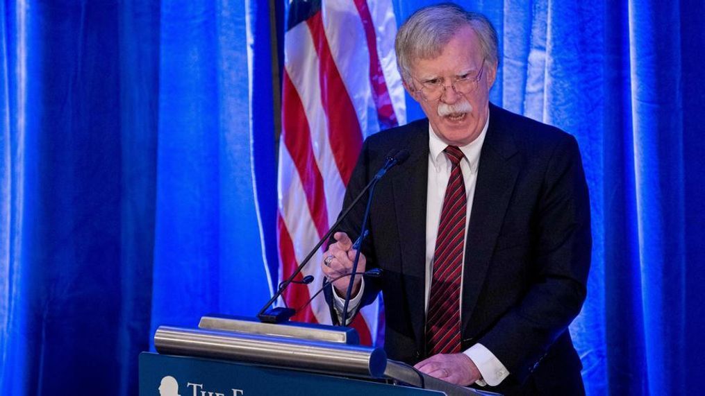 John Bolton speaking at a podium