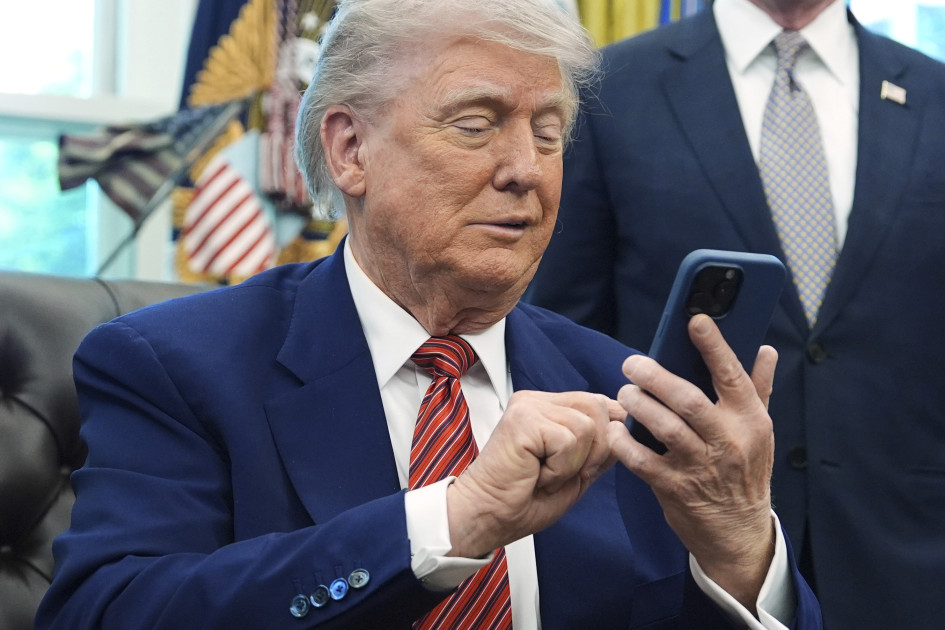 President Donald Trump on his mobile phone
