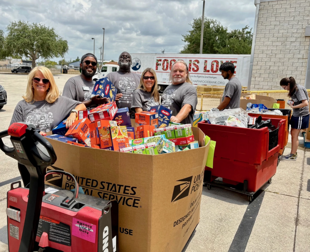 Volunteers help load packaged food items at the Page Field Post Office on Saturday during the 32nd annual Stamp Out Hunger Food Drive.