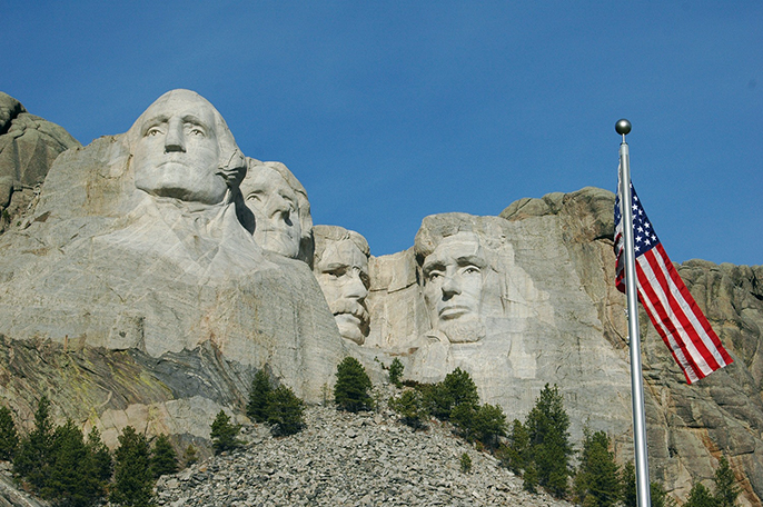 mount rushmore with american flag