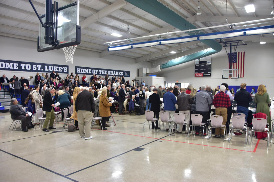 church congregation worshipping in gymnasium