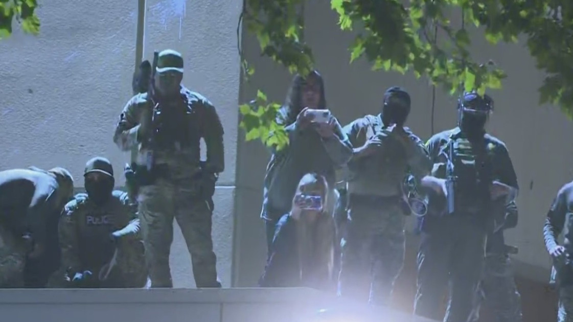 Portland police officers at ICE facility protest scene