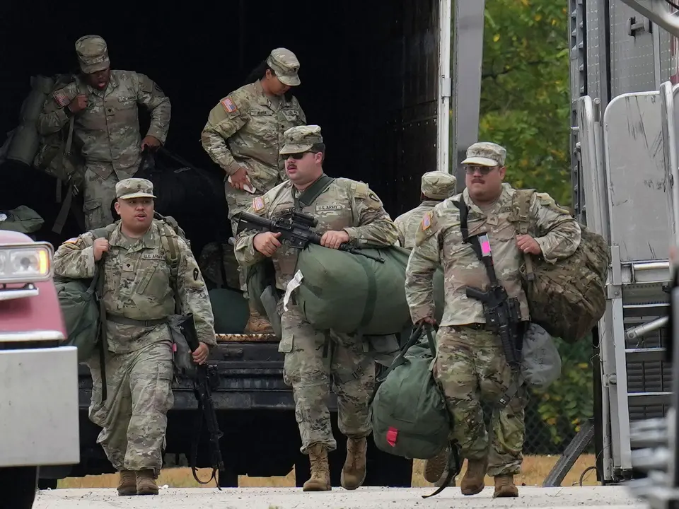 Military personnel in uniform, with the Texas National Guard patch on, are seen at the U.S. Army Reserve Center, Tuesday, Oct. 7, 2025, in Elwood, Ill., a suburb of Chicago. 

Erin Hooley/Associated Press


