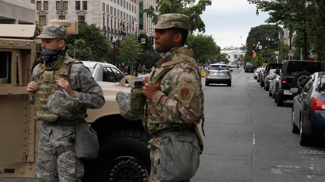armed National Guard members patrolling a U.S. city street