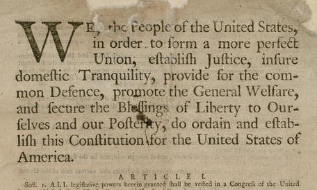 A close-up of the U.S. Constitution, focusing on the preamble